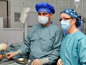 110910-N-8377A-133, CAMP SHAHEEN, Mazar-e Sharif, Balkh province, Afghanistan (September 10, 2011)  ANA operating room nurse Zahir Ahmad and U.S. Navy operating room nurse, Lt. Kathryn Wilgus (right) anticipate the surgeons next move during an IM Rodding surgery to fix a broken leg at the ANA Regional Military Hospital, located within Camp Shaheen. Members of the Regional Support Command North, Medical Embedded Training Team on Camp Mike Spann, along with a Swedish task force anesthesiologist who was at Provincial Reconstruction Team, Mazar-e Sharif, provided operating room support for the procedure alongside ANA medical personnel. (U.S. Navy Photo by Chief Mass Communication Specialist Michael Ard/Released)